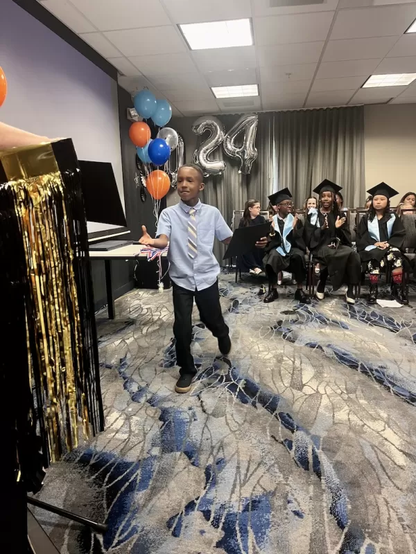 Child receiving a diploma