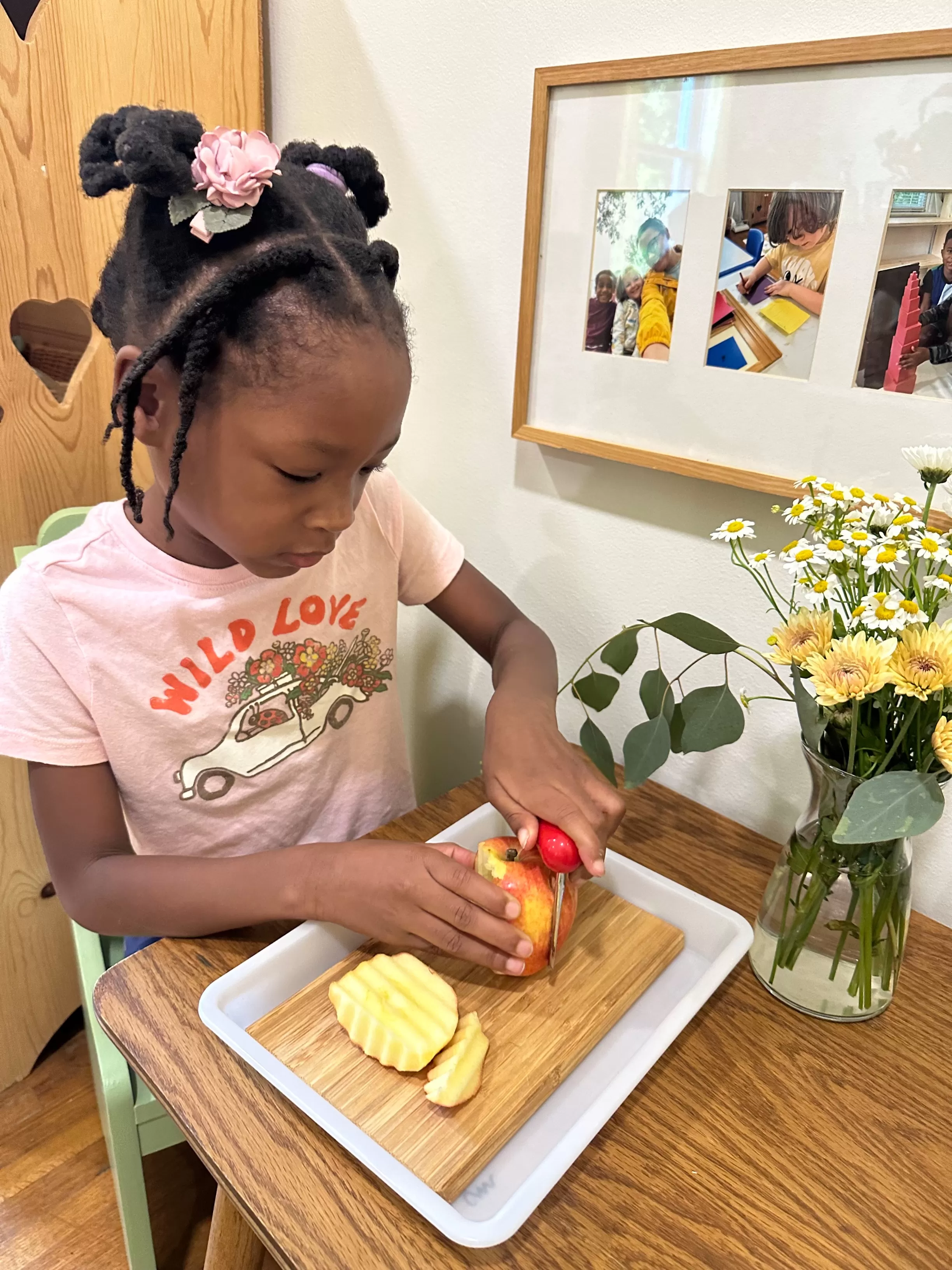 Primary child cutting apple