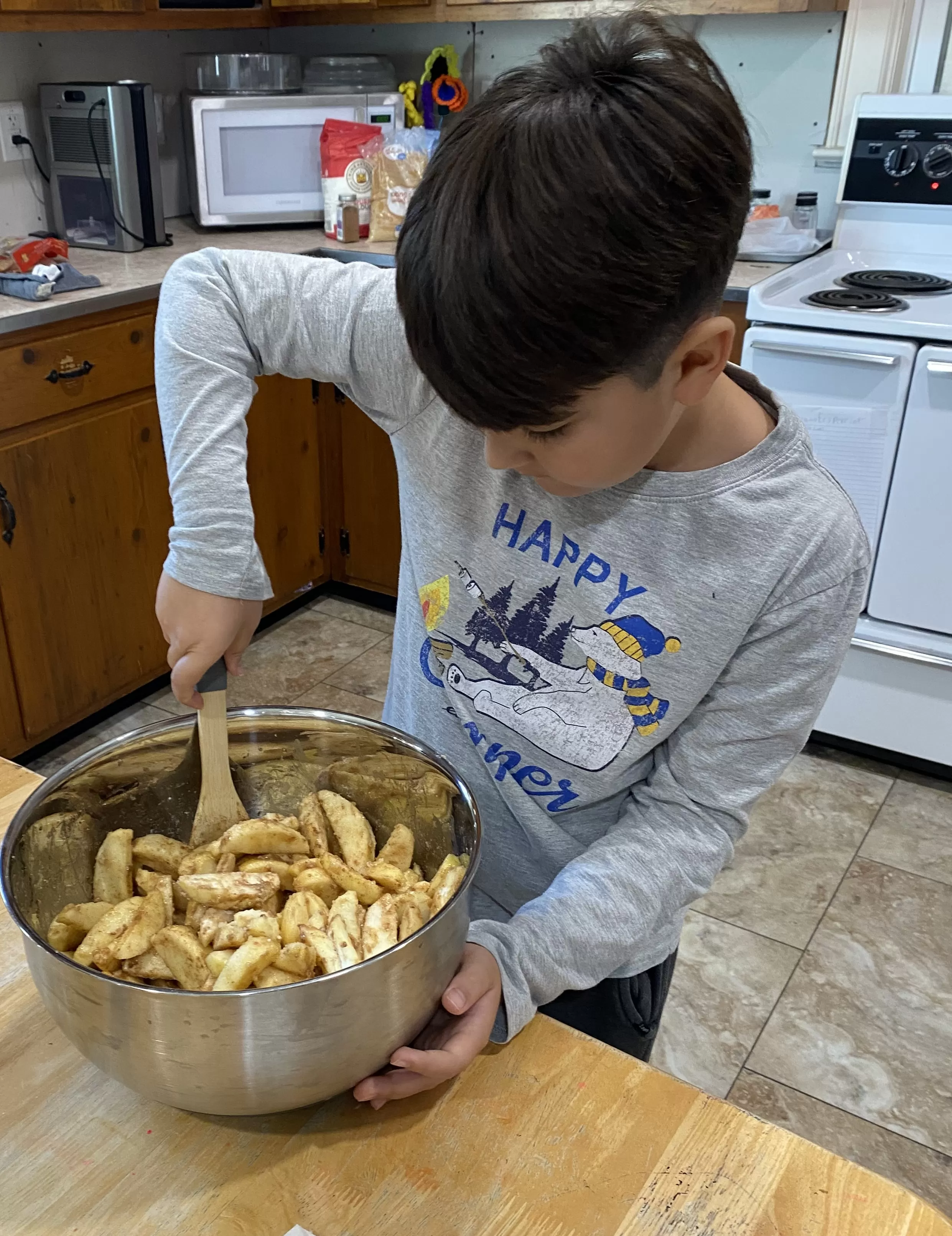 Elementary student making apple pie